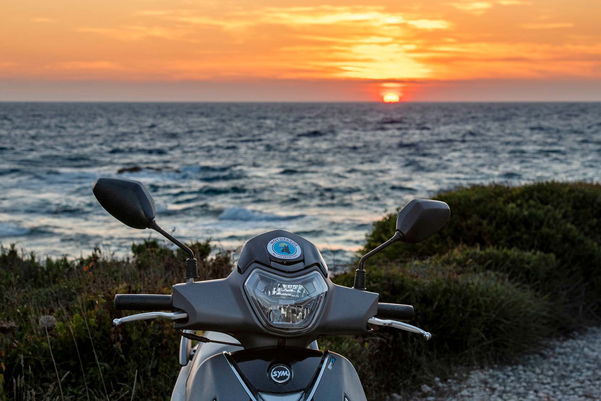 Moto Paxos grey scooter by the sea